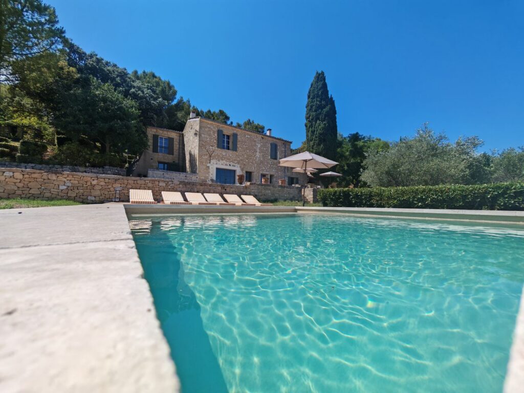 Stunning Mediterranean villa with pristine pool, lush greenery, perfect summer retreat.